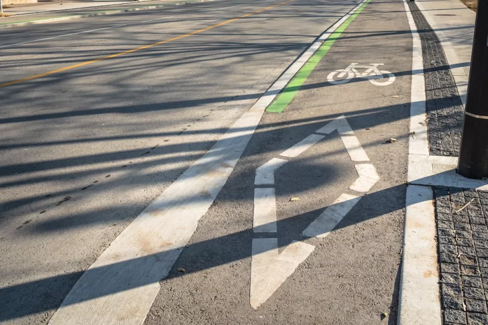 Painted bike lane with bike symbol and diamond on street in downtown Toronto, Ontario.